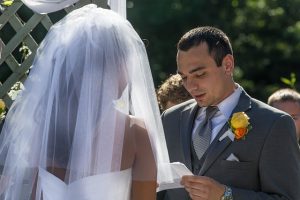 Groom reading vows to bride